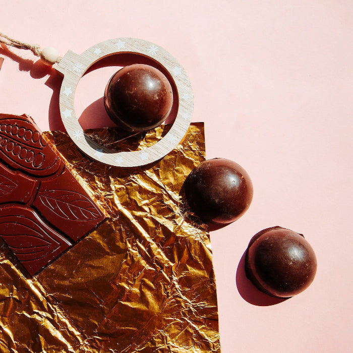 this is an image of 3 chocolate balls on top off foil and a block of temepred chocolate, great for low-tox and organic Australian made gifting, valentine's and galentine's and Christmas, gifts for her and him.