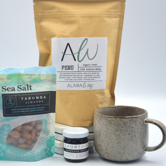 Photo of a coffee hamper with mug, nuts and honey