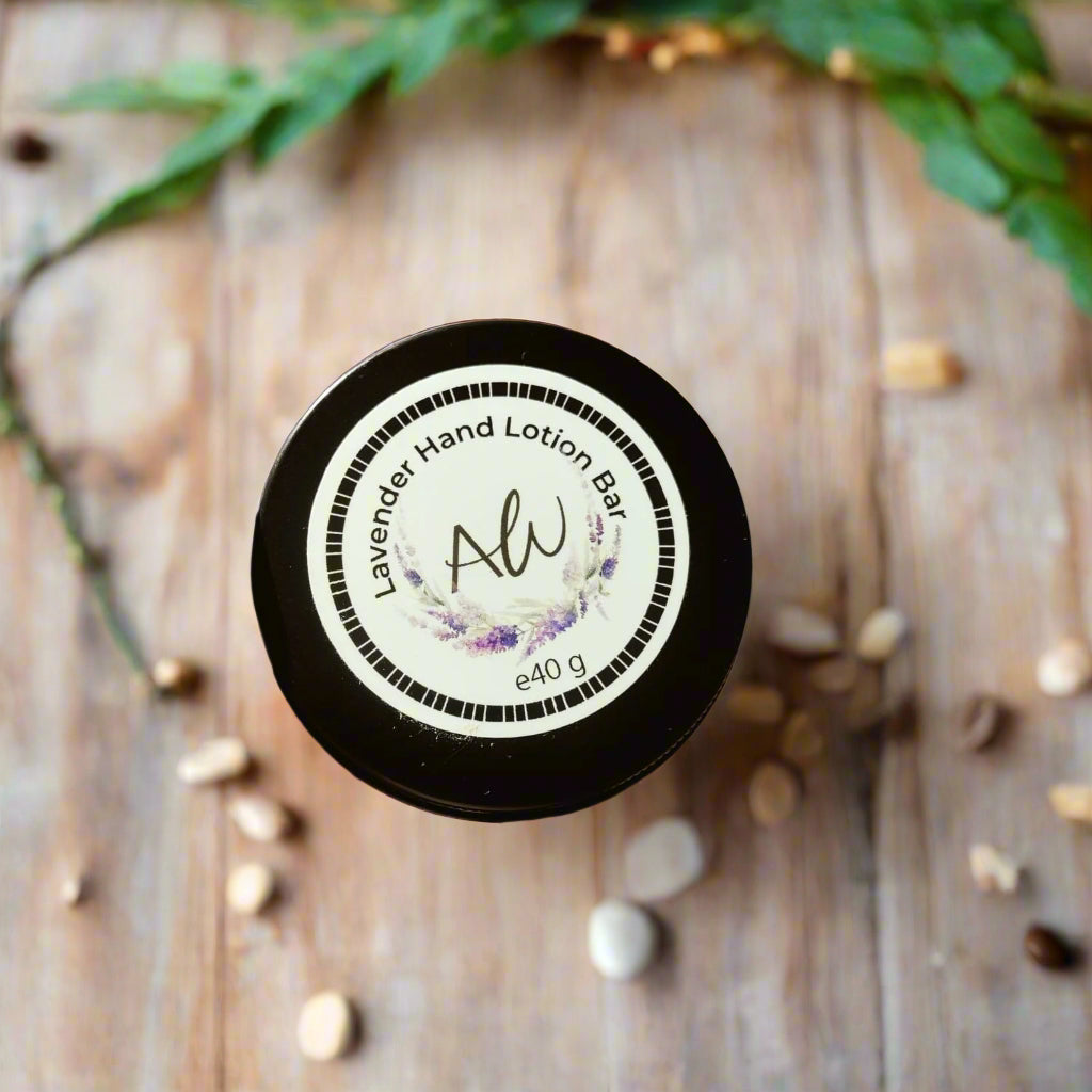 A hand holding a black lotion bar labeled 'Alaraway Hand Lotion Bar' with a weight of 40 gm, against a brick wall background.