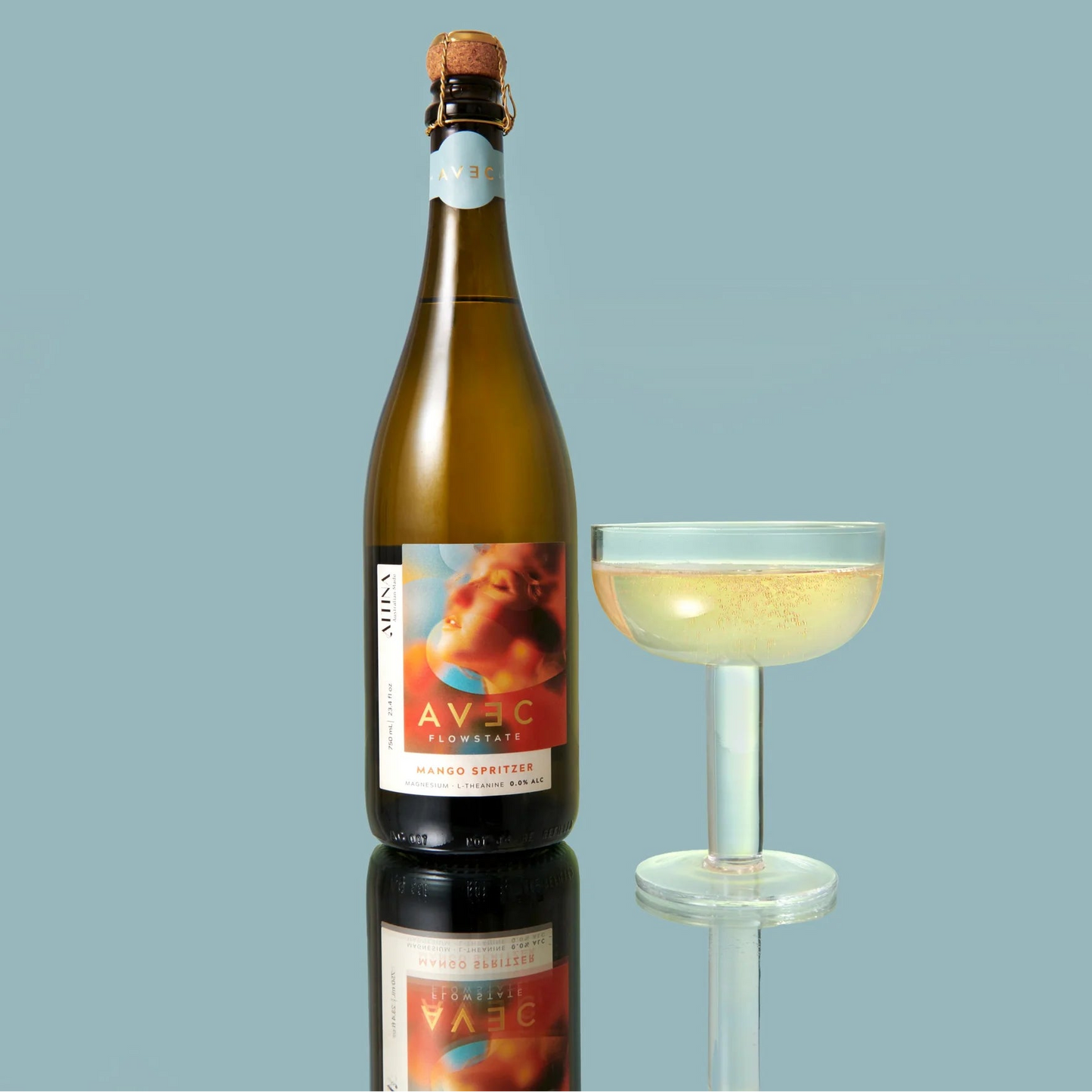 Bottle of Avec sparkling wine with a glass on a light blue background