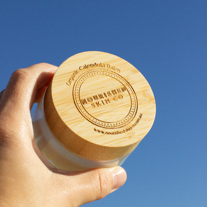 This is an image of someone holding calendula balm