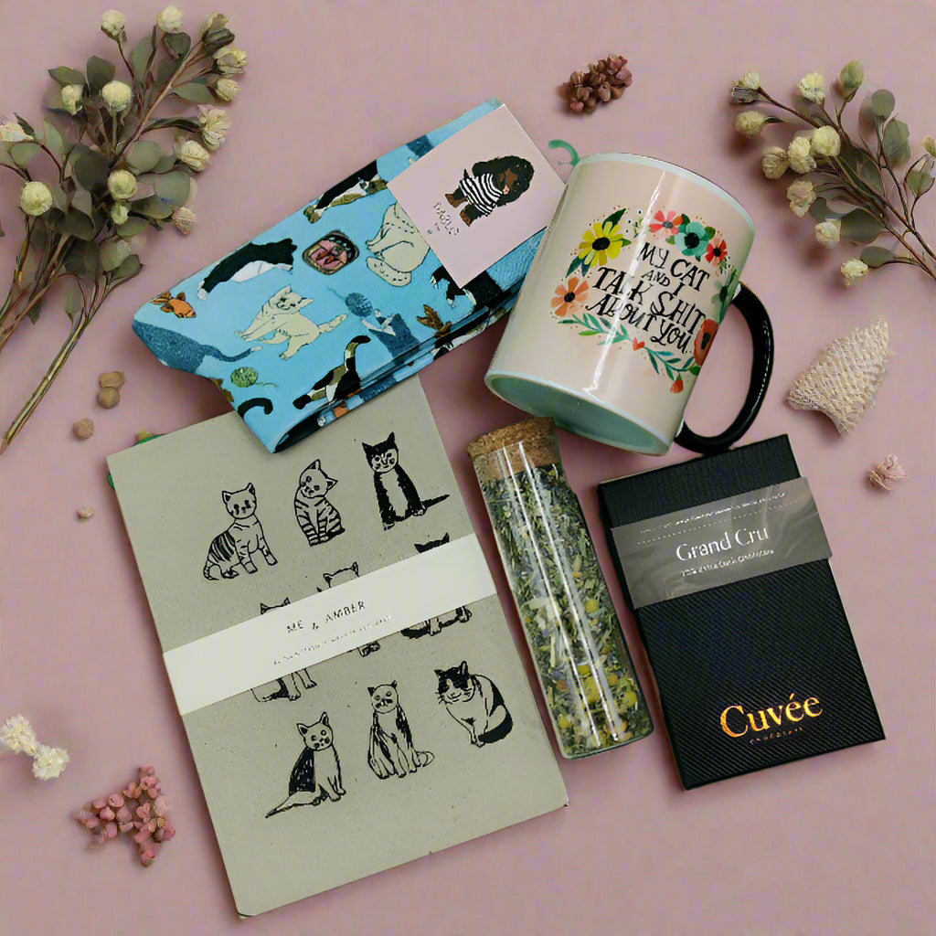 this is an image of the products in my cat gift hamper box on a pink background