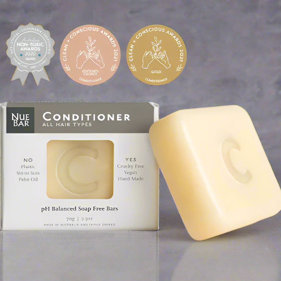 A packaged bar of NueBar Conditioner for all hair types, with organic and vegan certification seals, indicating the product is vegan and organic.