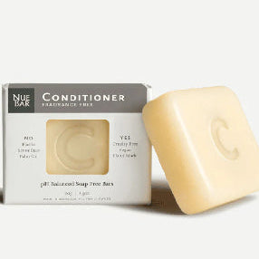 A packaged solid conditioner bar next to its box, labeled as fragrance-free with organic extra virgin olive oil.