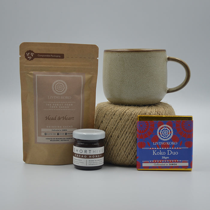 A ritual box for cacao ceremonies including a premium ceramic mug, a jar of cacao infused Australian honey, and a sachet of premium ceremonial grade cacao.