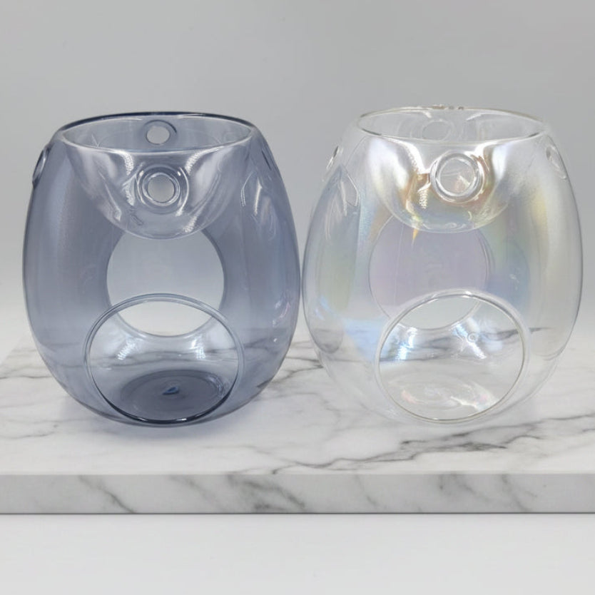 Two glass wax burners, one with a blue tint and the other clear