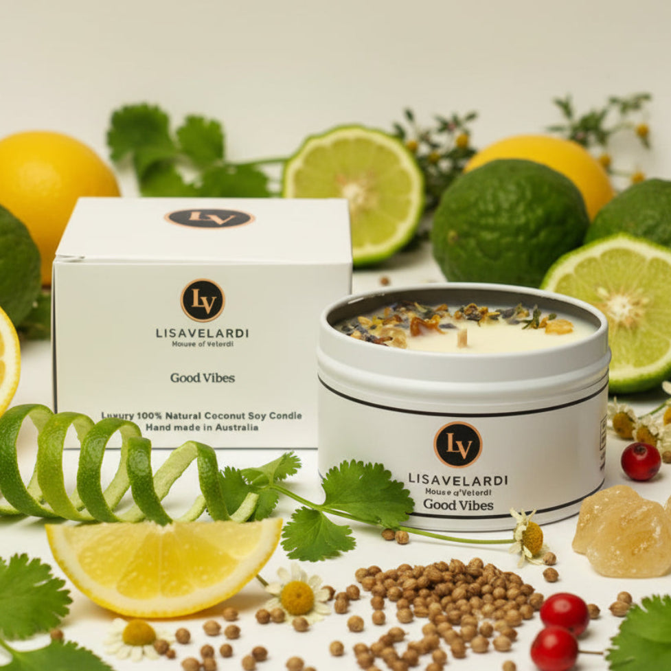 Lisavelardi candle with packaging on a table with lemons, limes, and herbs.