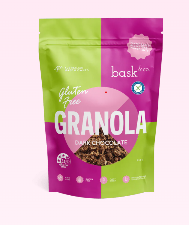 Bag of gluten-free dark chocolate granola with 'bask & co' branding on a light pink background