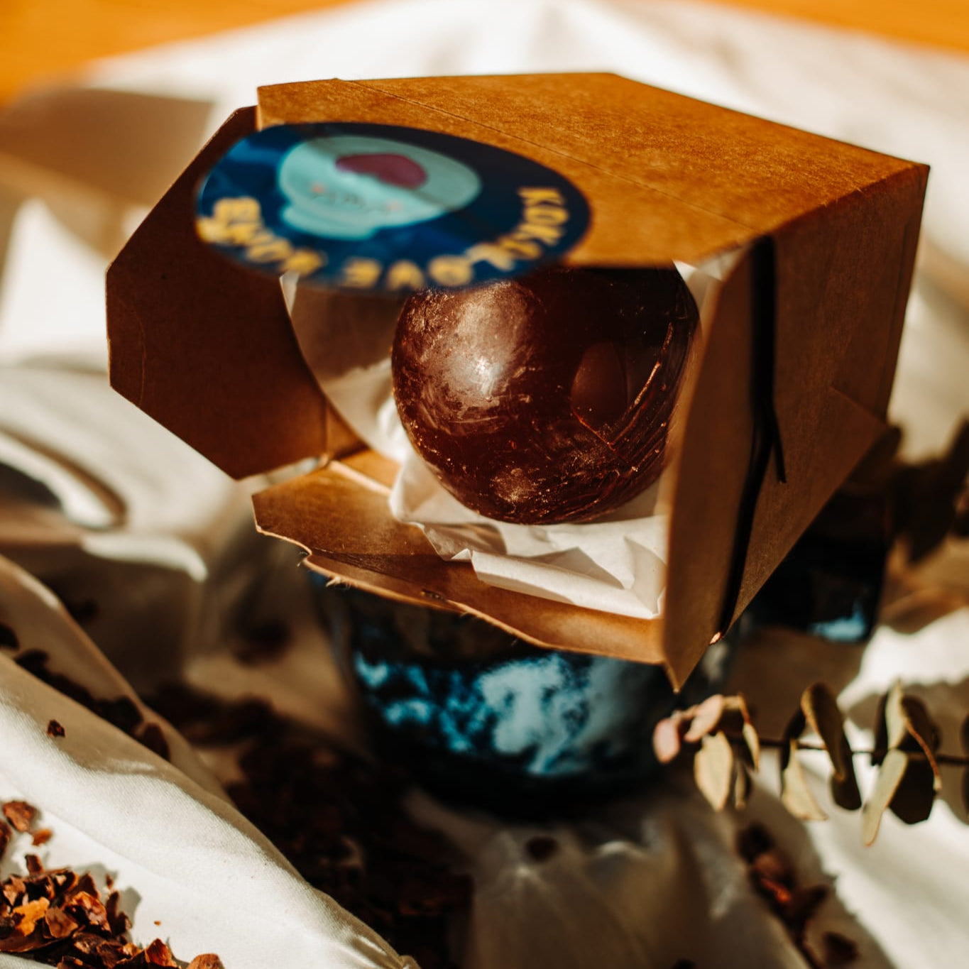 This is an image of a chocolate ball in a paper box, great for low-tox gifting and valentines too