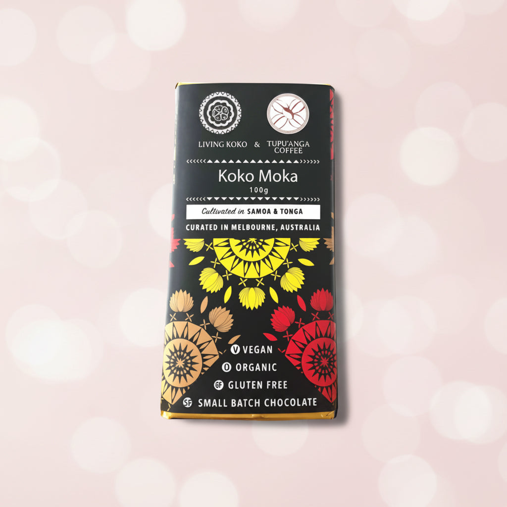 A chocolate bar packaging with a colorful design featuring geometric shapes in red, black, and yellow. The text indicates the product is 'Koko Moka', 100g, made with organic dark chocolate and tupu'anga coffee, vegan, organic, and gluten-free.