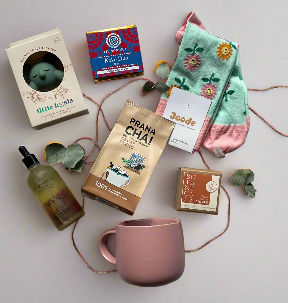 Collection of tea bags, a mug, and decorative items on a light surface