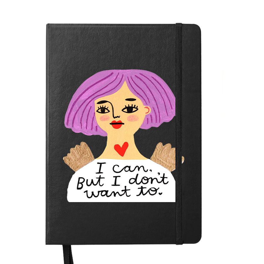 A5 sized notebook with a soft-touch black cover featuring a doodle of a grumpy angel character with the text 'I can but I don't WANT TO.' next to a pencil.