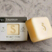 Shampoo bar and packaging on a marble surface