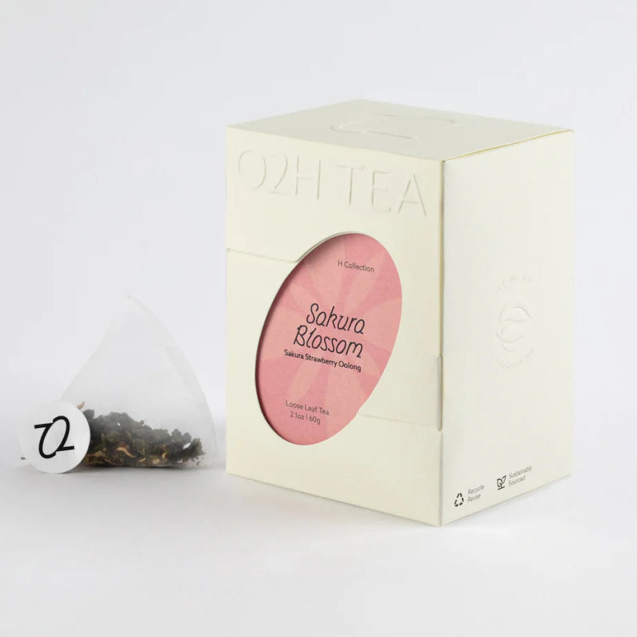 this is an image ofa sakura blosom tea box and a tea bag next to it