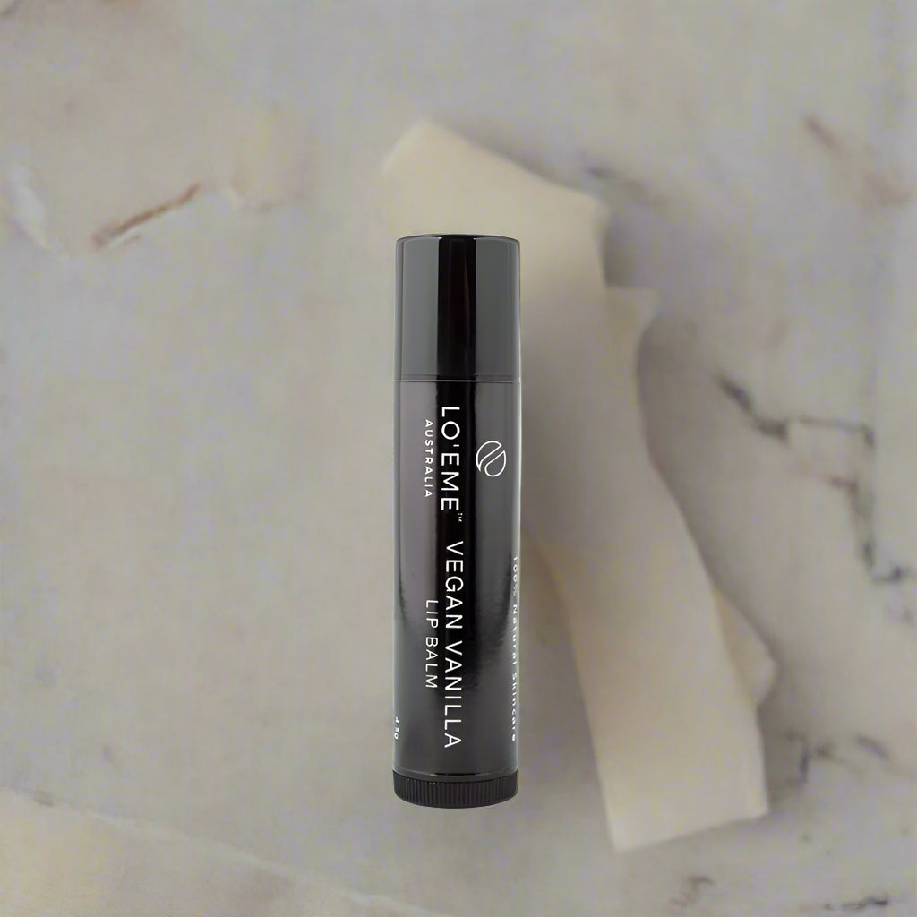 Black lip balm container with 'LOE ME' branding on a white background