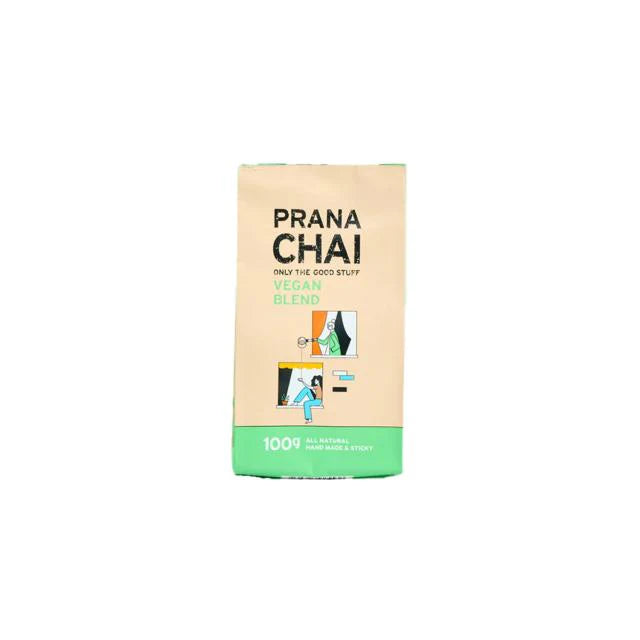 A package of Prana Chai Vegan Blend tea in a beige and green bag with an illustration showing a person preparing tea.