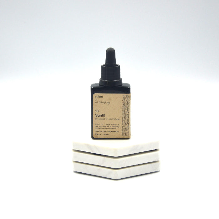 image of a glass oil bottle of essential oils created by Alara way