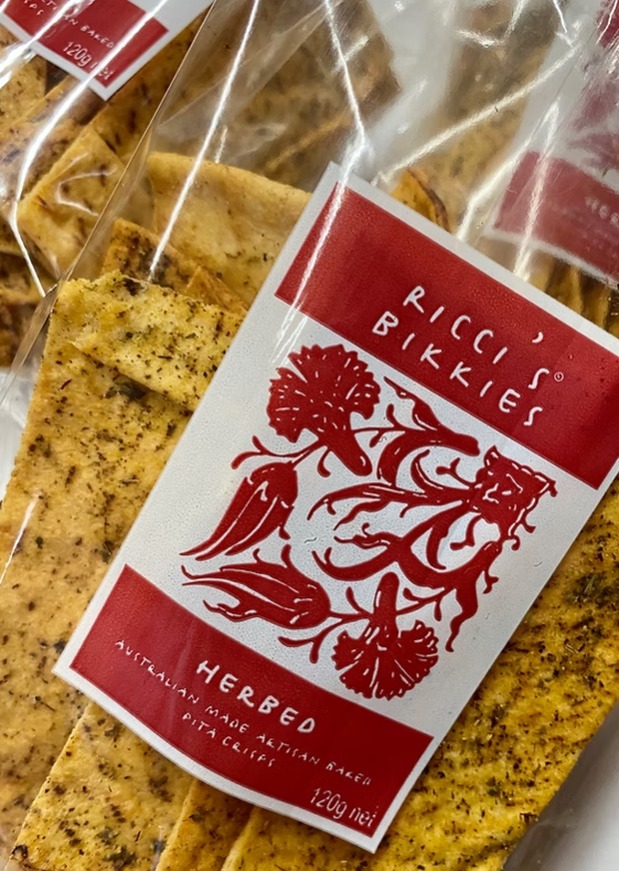 Herbed crackers with a 'Picci's Bikkies' label featuring a red chili pepper design.