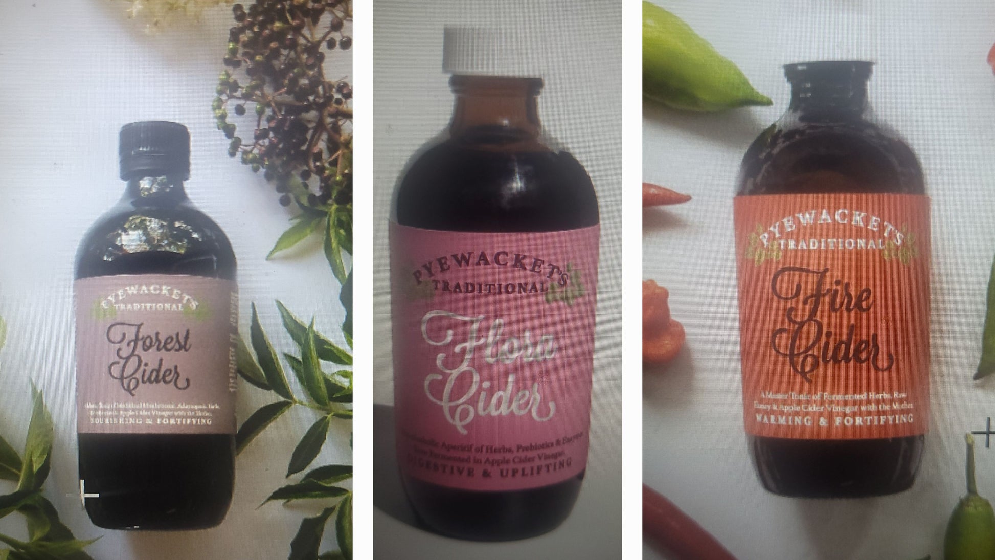 Three bottles of Pyewacket Cider with different flavors on a white background.