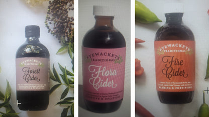 Three bottles of Pyewacket Cider with different flavors on a white background.