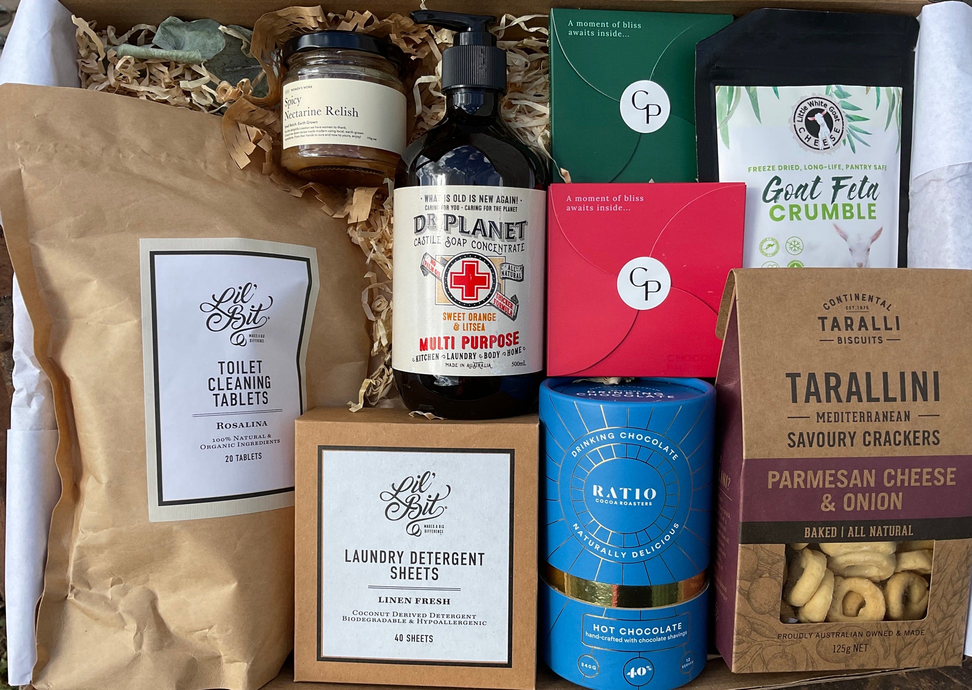 Gourmet gift basket with various products including coffee, soap, and crackers.