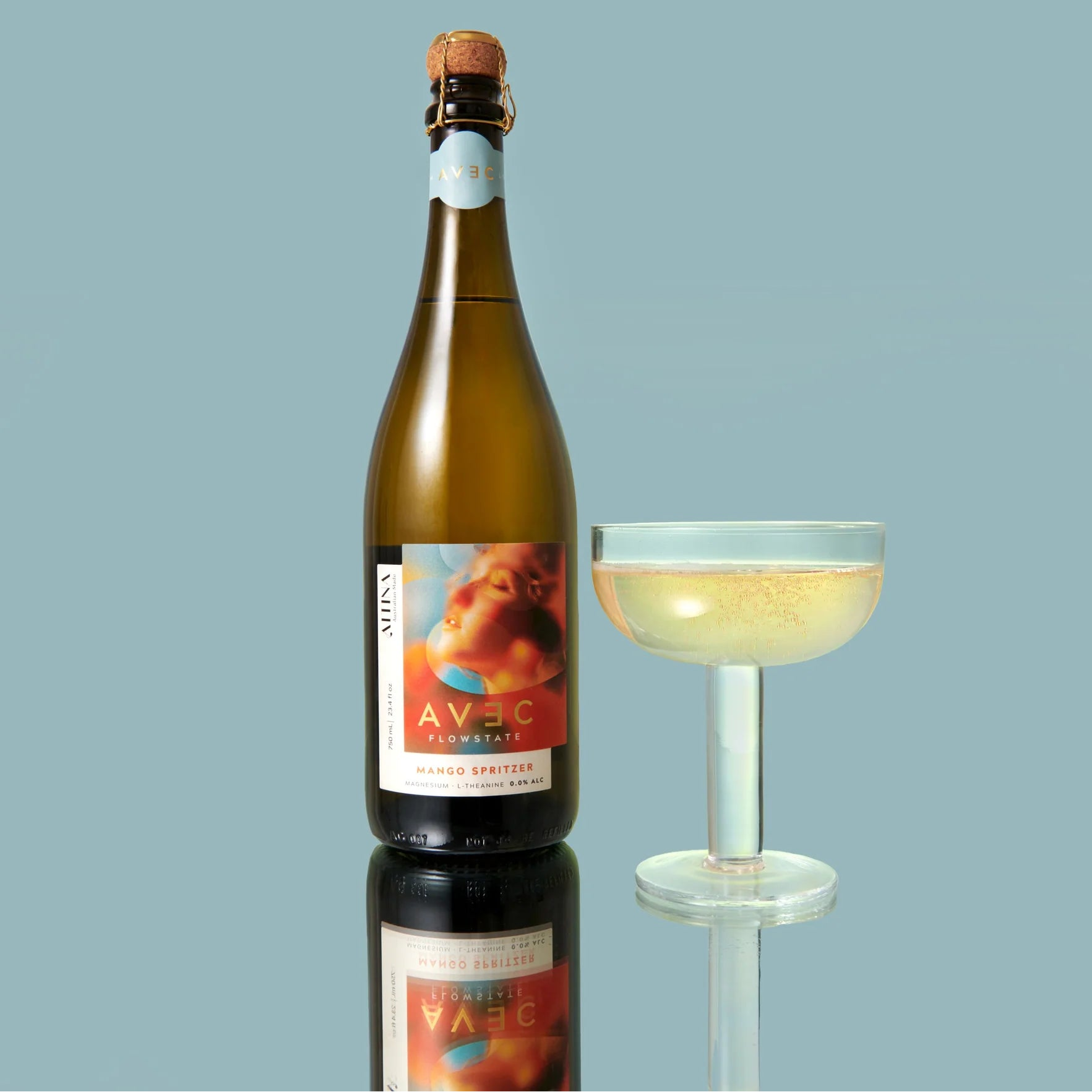 Bottle of Avec sparkling wine with a glass on a light blue background
