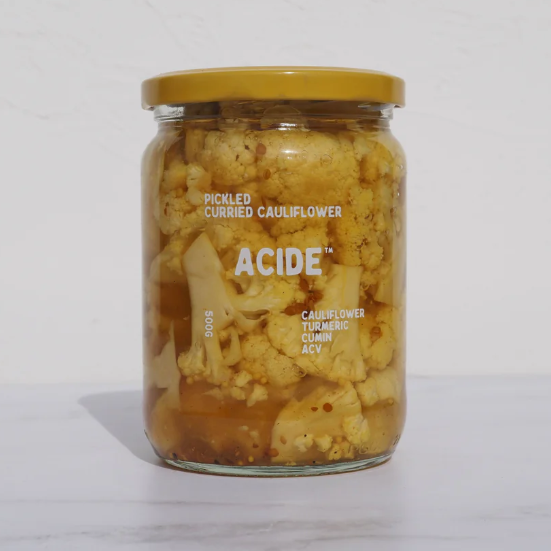 Jar of pickled curried cauliflower with 'Acide' branding on a white background