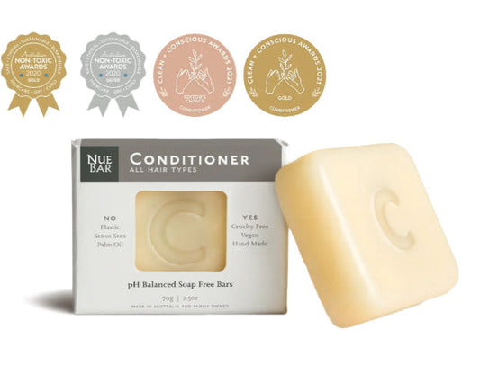 A packaged bar of NueBar Conditioner for all hair types, with organic and vegan certification seals, indicating the product is vegan and organic.