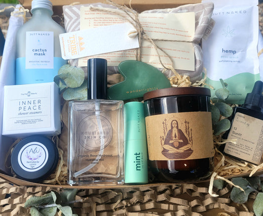 Assorted beauty and wellness products in a box with visible branding.