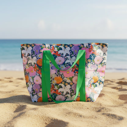 Floral tote bag with green handles on a light gray background