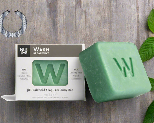 Green soap bar with 'W' logo next to its packaging on a white background, featuring the 2022 Organic Beauty Award winner badge.