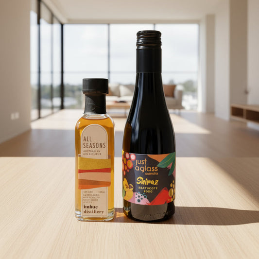 Two bottles of alcohol on a table with a modern interior background