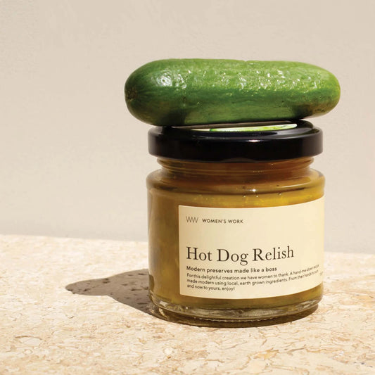 Jar of Hot Dog Relish with a green lid on a beige background