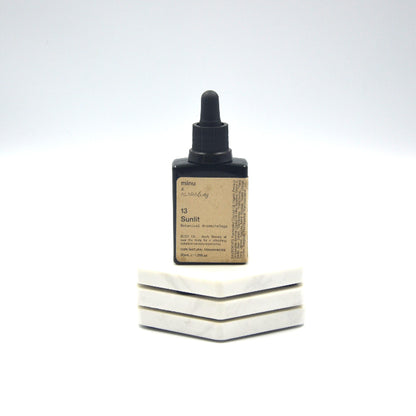 image of a glass oil bottle of essential oils created by Alara way