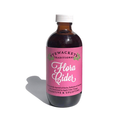 Bottle of Hye Wackett's Traditional Flora Cider with a pink label on a white background