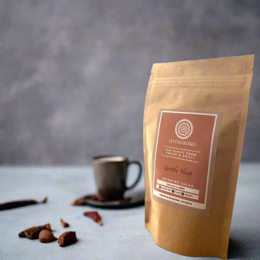 Kraft paper packaging of LIVING KOKO cacao on a wooden surface with a white background