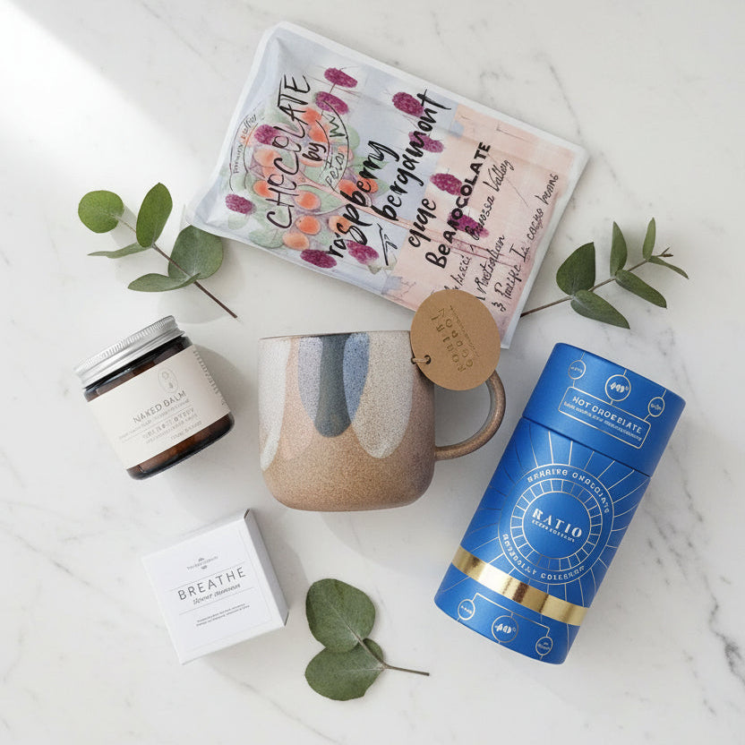 Gift set with a mug, drinking chocolate,  barossa valley chocolate ,moisturising cream and shower steamer.