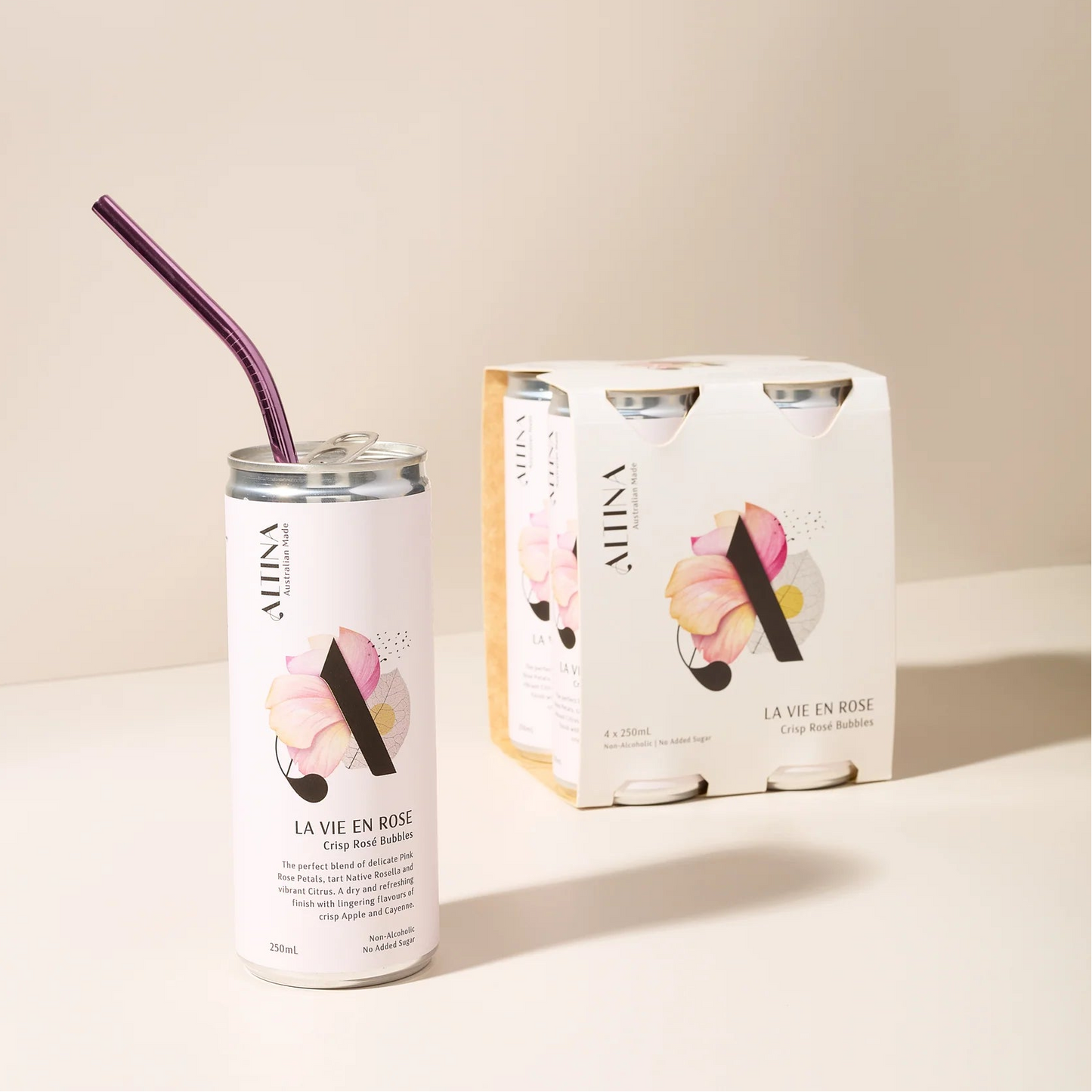 Alina La Vie en Rose can with a straw and packaging on a light surface.